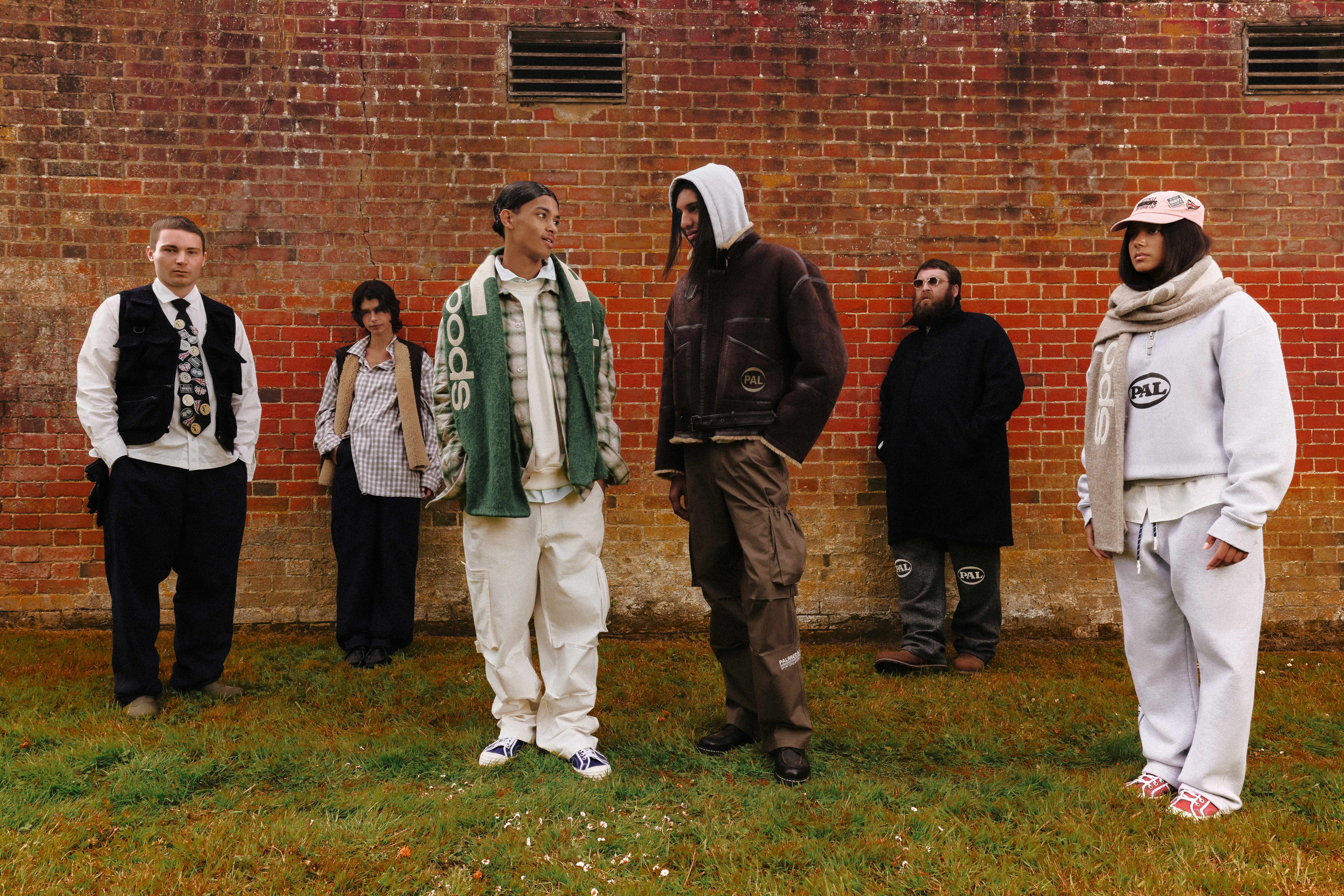 PAL Sporting Goods AW25 campaign, group in front of a brick wall